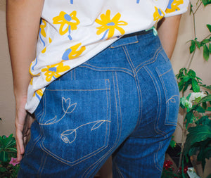 Waverly Jeans,Wave Seams,Floral Stitch Detail,High-Waisted Design,Boot-Leg Hemline,Upcycled Deadstock,Sustainable Fashion,Reducing Landfill Waste,Doppelganger Denim,Wardrobe StapleVersatile Styling,,Twinning Looks,Unique Seam Detailing,Eco-Friendly Jeans,Sustainable Style,Fashionable Denim,Button Closure,Back Pocket Embellishments,dubai fashion,functional,Pair of jeans